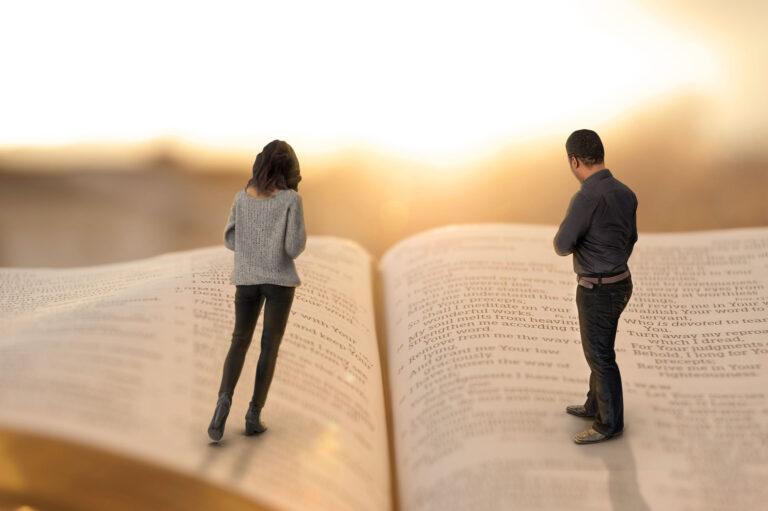 Woman and man standing on open page of Bible with bright sun in background.
