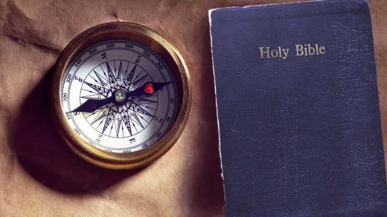 Compass heart pointing at Bible