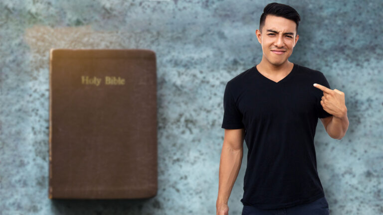 Young man pointing to himself, in the background is a Bible