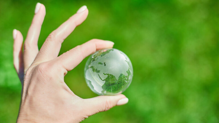 Hand holding small glass globe