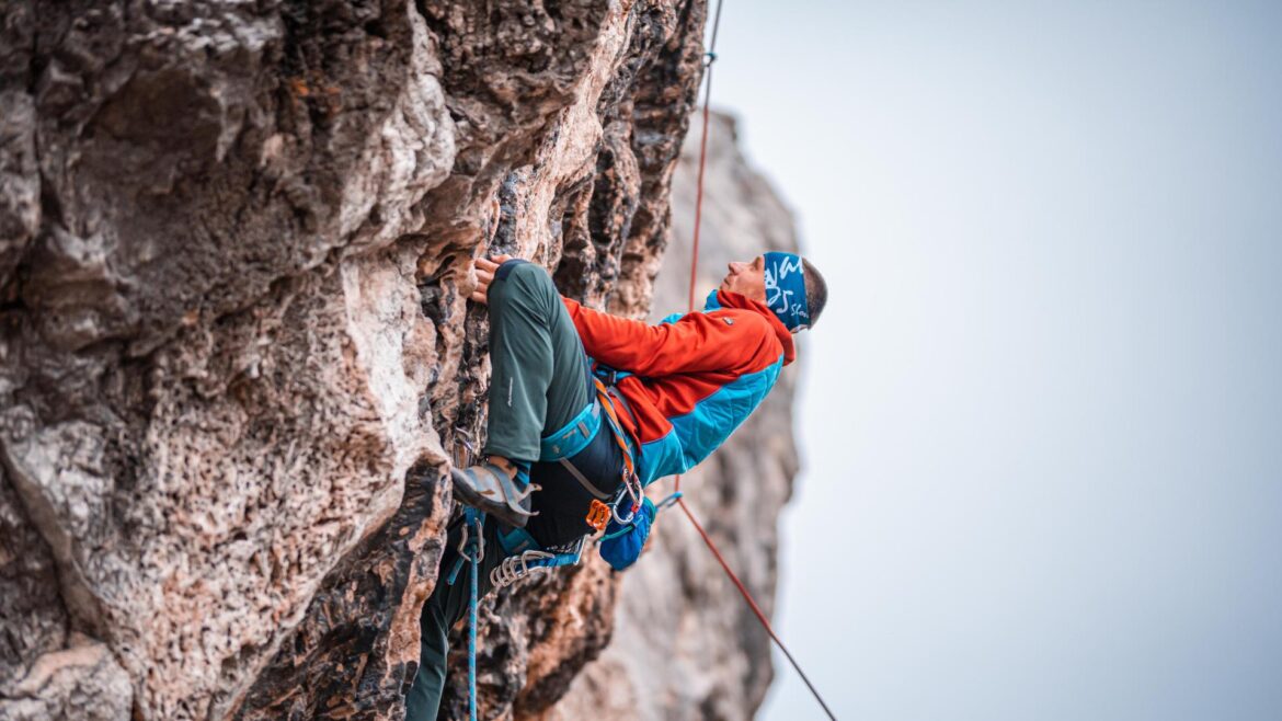 Mountain climber on a sheer cliff face