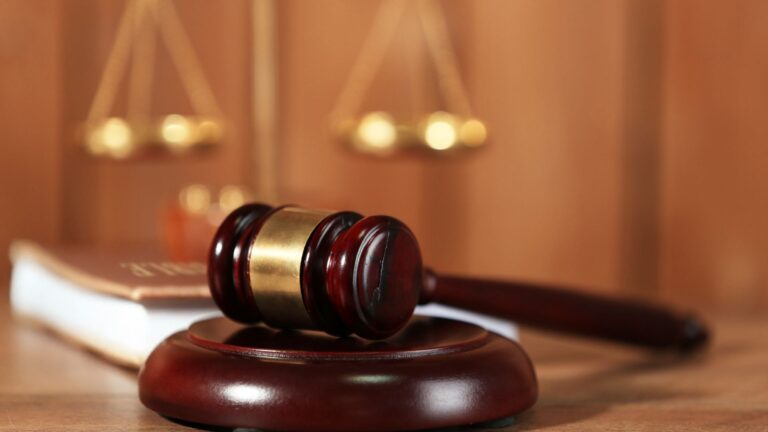 Close-up shot of a judge's gavel resting on it's base.