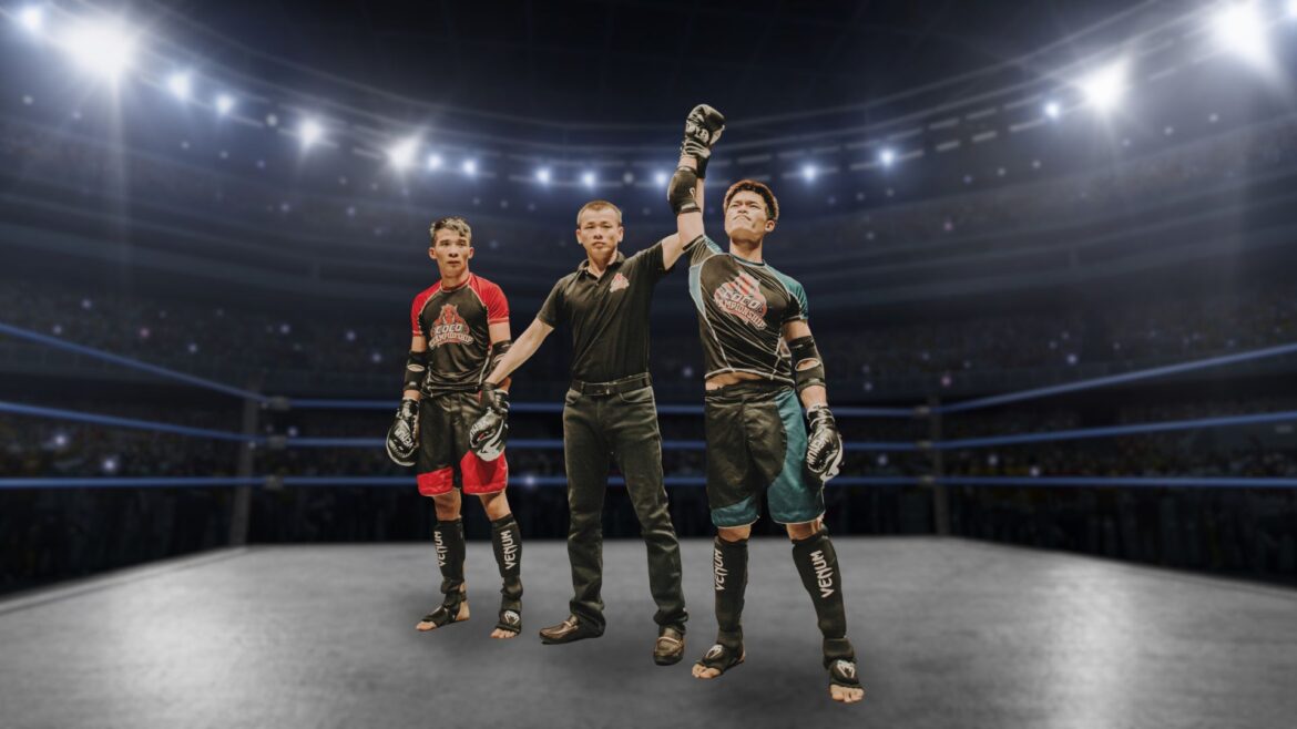 3 young men in a fighting ring dressed as competitors and referee with the referee raising the hand of one man as victor