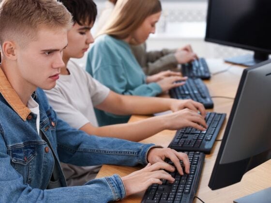 Students completing a digital worldview survey on classroom computers.