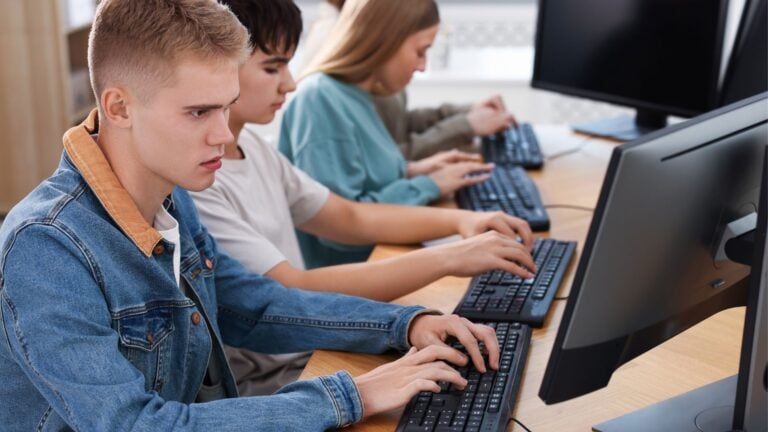 Students completing a digital worldview survey on classroom computers.